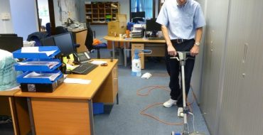 Man Cleaning Office Space Vaccum Cleaner